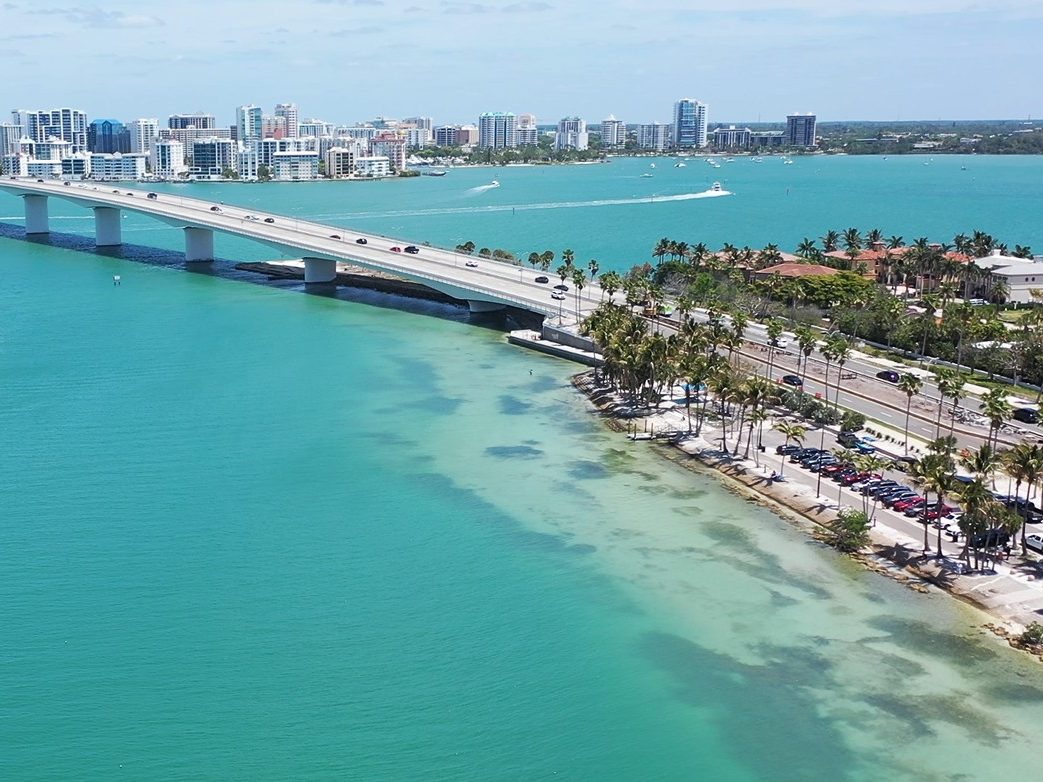 The John Ringling Causeway seen from Bird Key Park, with the downtown Sarasota skyline across the turquoise shallows of the bay